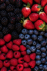 Fresh summer wild berries : strawberry,blackberry,raspberries,blueberry. Full frame. Close up photo. Top view.