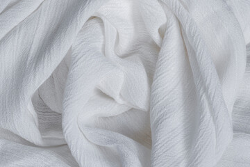 Wrinkled white viscose fabric. Artificial fiber from natural wood pulp. Textile texture as...