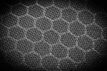 Vignetted textile material with a hexagonal pattern. Black and white background