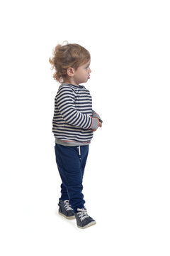 Side View Of A Baby Boy Walking And Looking Away White Background