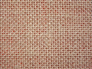 Jute fabric with pink undertone close-up as background. High quality photo