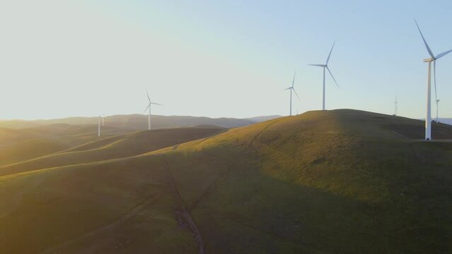 Aerial drone view of wind power plant on green hills near Livermore, California.
