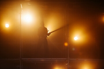 Musical show. Rock musician silhouette. light of light.