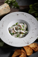 Scallop in garlic sauce with parsley and croutons. Close-up