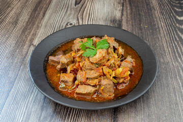 Roasted lamb liver with onions and tomatoes.