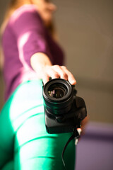 blurred background girl holding a camera. camera in photographer's hand