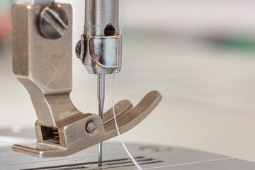 Sewing machine needle with thread and fabric