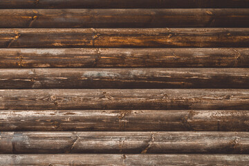 Wooden wall from log as background. Obsolete carpentry boards, panel. Surface of wooden texture for design and decoration. Dark brown horizontal wood plank grunge texture. Rustic backdrop. Copy space.