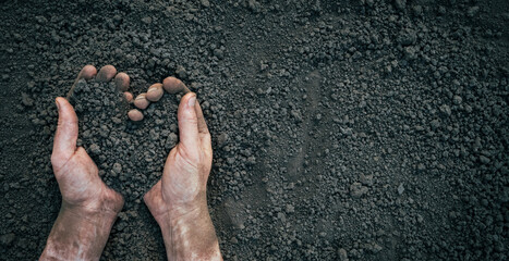 Symbol heart earth day. Handful of dirt hands heart shape. Farm organic earth. Farmer hands soil...