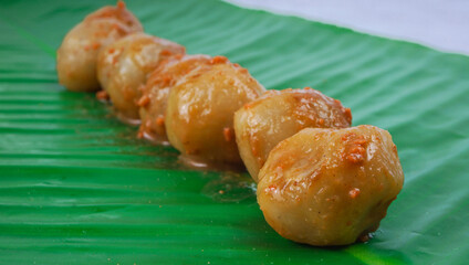 Cilok is one of Indonesian street food, made from tapioca flour and served with chilli sauce. Served on banana leaf. selected focus