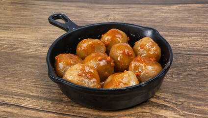 Cilok (Aci Dicolok) is a Sundanese snack originated from Indonesia. served in wok pan with peanut sauce