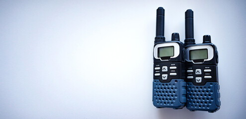 Two portable walkie-talkies on a white rectangular background.Communication device for rescuers and the military. Black radio station.