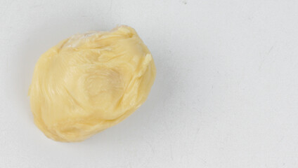 Fresh ripe durian meat on white plate.