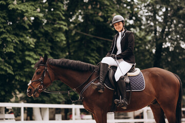 Equestrian sport - a young girl is riding a horse