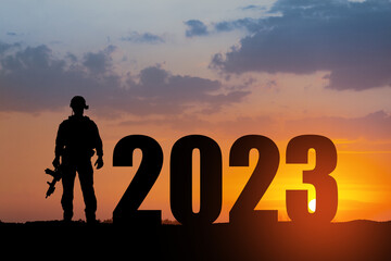 Silhouette of soldier and 2023 against the sunrise or sunset. Armed forces. Concept of military...