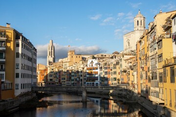 Fototapeta na wymiar Girona Cathedral and Basílica de Sant Feliu seen from the across the river