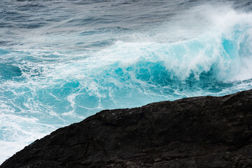 North coast of Gran Canaria, Canary Islands, waves breaking against dark lava rocks.