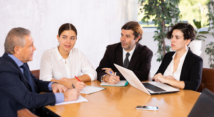 Meeting of top managers in meeting room in a modern office