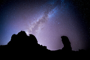 Naklejka na ściany i meble Milky way in Teide national park in Tenerife, canary island. background stars over a massive rock formation