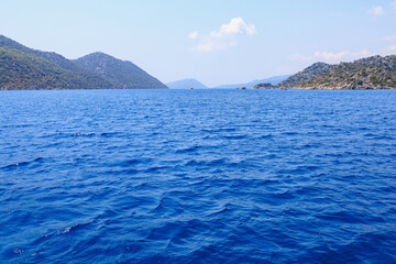 Obraz premium View of the rocky shore from the sea. Mediterranean Sea in Turkey. Popular tourist places. Background
