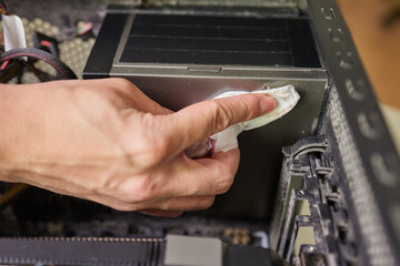 Internal parts of an old personal computer. Dusty motherboard, video card and fan. The master...