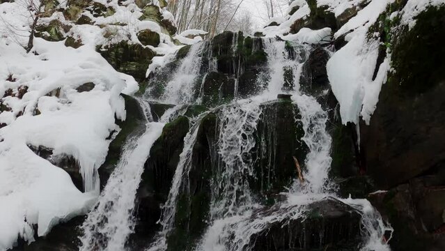 A waterfall on the northern slopes of the Polonyna Borzhava mountain massif at the foot of Mount Gemba in the Ukrainian Carpathians. Shypit waterfall. Winter in the mountains of Ukraine