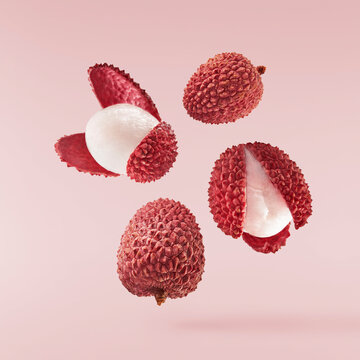 Fresh ripe red lychee falling in the air isolated