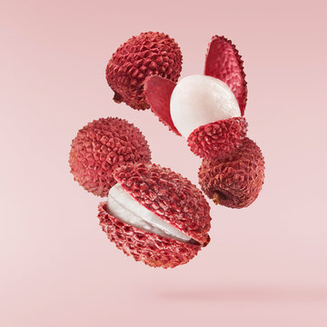 Fresh ripe red lychee falling in the air isolated