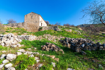 Stone church in the ruins of Acrocorinth fortress on a sunny day.