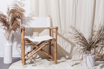 Stylish boho compostion at living room. Home decor concept