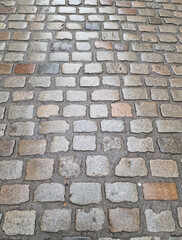 A fragment of a cobbled street in the Old Town in Gdansk on a rainy autumn day, Gdansk, Poland.