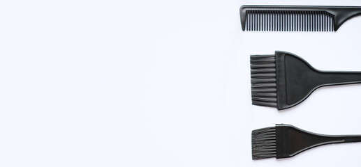 Top view, flat lay, hair coloring accessories, brushes and combs isolated on white background