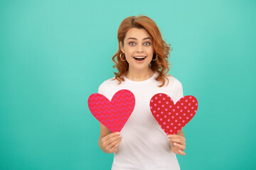 amazed young lady with red heart on blue background