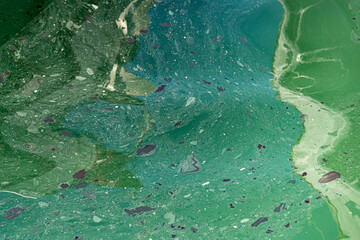 Toxic chemicals, fuel oil stains, and human garbage disposals floating on surface of sea waters