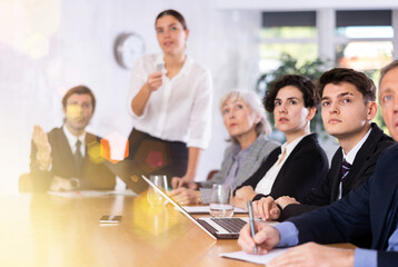 Group of diverse business people attending meeting in conference room, discussing work plan