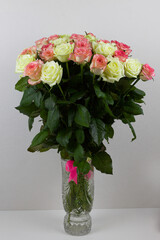 Bouquet of pink, yellow roses. Composition of multi-colored roses. Background for a postcard.