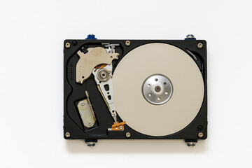 Disassembled hard drive on a white background, isolated. The electronic insides of the information storage device, the reading head.