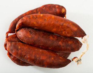 Spanish sausage chorizo on white background, closeup