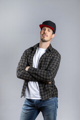 Man in casual clothes posing looking at camera isolated on gray background