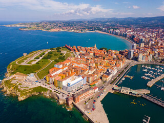 Aerial view of cityscape and marina of Spanish city of Gijon in sunny summer day