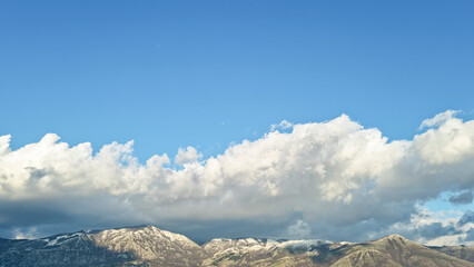 Panoramic view of Snowy winter mountains with clouds formation,cold season weather
