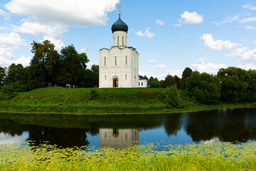 View of Orthodox Church of Intercession of Holy Virgin on Nerl River in Russian village of Bogolyubovo on sunny summer day, Suzdal district, Vladimir Oblast