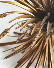Wheat-motif sheaf coffee table base.	 Vintage gold unique design. Close-up detail.