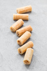 Mini sweet waffle rolls. Light grey background	