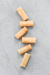 Small sweet waffle rolls. Light grey background. Top view