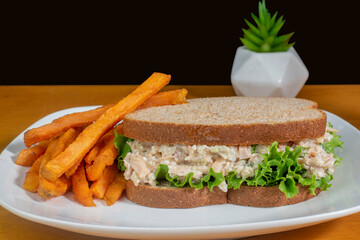 chicken salad sandwich  with a side of sweet potato fries