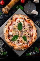 Pizza with chicken ham, cheese parmesan, mozzarella, champignon mushrooms, tomato sauce, fried onion and spinach on thick dough from the oven.
