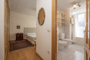 Double bedroom with built-in wardrobe and an en-suite bathroom with a bathtub with curtains