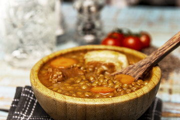 A wonderful Spanish stew of lentils with chorizo in a bamboo wood bowl