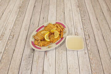 Tray of chopped battered fried chicken fillets with lemon sauce cooked in a Chinese restaurant